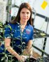 Dr. Sarah Strauss in greenhouse with weeds